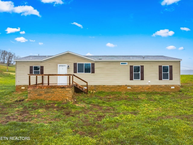 back of property featuring a yard