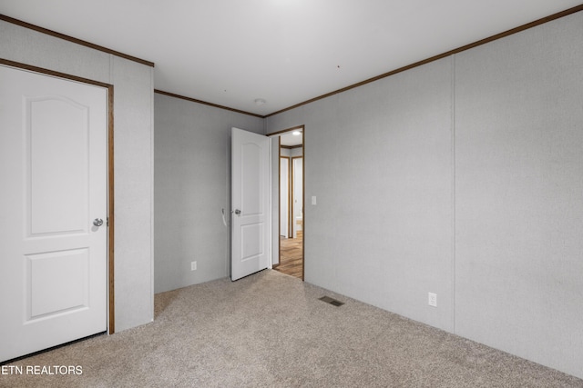 unfurnished bedroom with carpet and ornamental molding