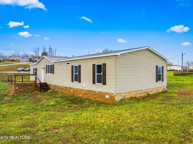 view of side of property with a yard