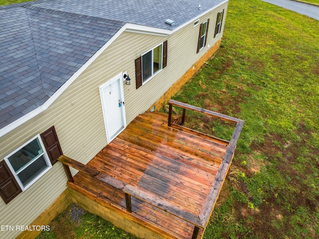 entrance to property with a lawn