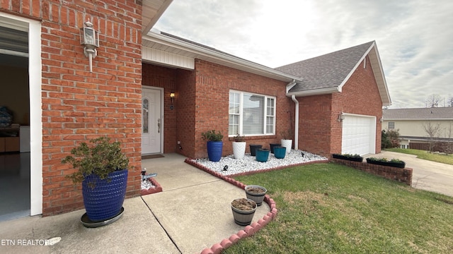 entrance to property with a yard and a garage