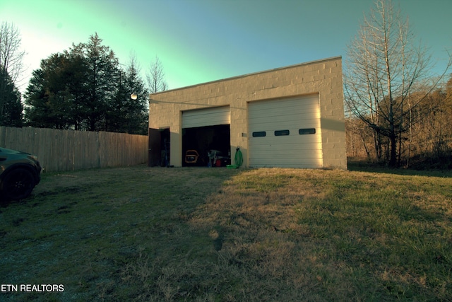 garage featuring a lawn