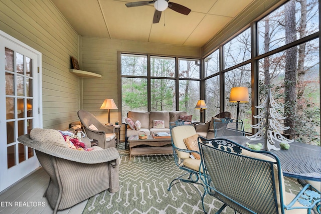 sunroom featuring ceiling fan