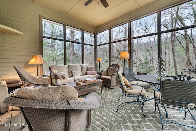 sunroom / solarium featuring ceiling fan