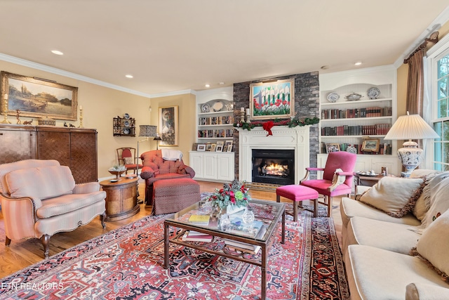 living room with hardwood / wood-style floors, crown molding, and built in shelves