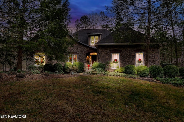 craftsman-style home with a lawn