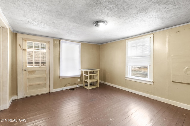 1886 5th St, Jellico, TN 37762 - unfurnished room with a wealth of natural light, dark hardwood / wood-style floors, and a textured ceiling