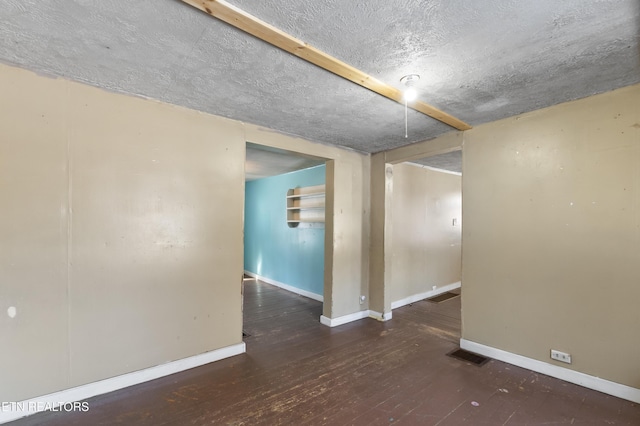 1886 5th St, Jellico, TN 37762 - empty room with dark hardwood / wood-style floors and a textured ceiling