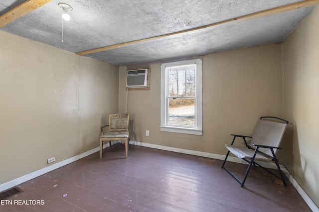 1886 5th St, Jellico, TN 37762 - unfurnished room with dark wood-type flooring, a wall mounted AC, and a textured ceiling