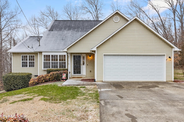 view of front of property with a front yard and a garage