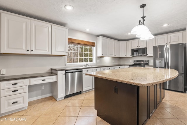 kitchen with sink, appliances with stainless steel finishes, and white cabinetry