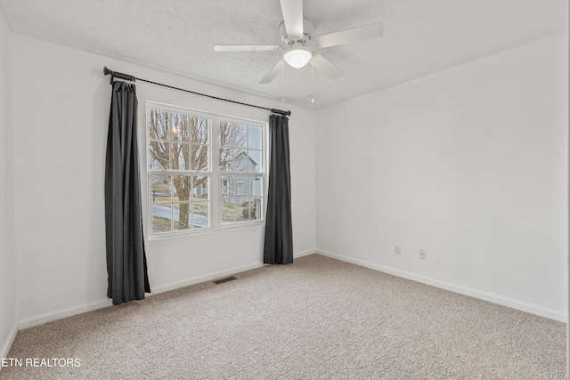 carpeted empty room featuring a textured ceiling and ceiling fan