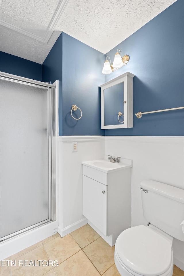 bathroom featuring tile patterned flooring, toilet, vanity, a textured ceiling, and an enclosed shower