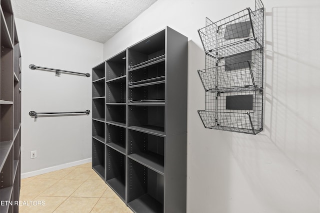 spacious closet with light tile patterned floors