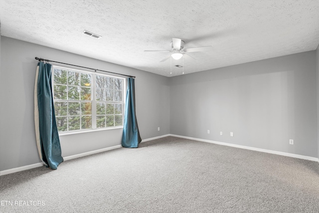 unfurnished room with carpet floors, ceiling fan, and a textured ceiling