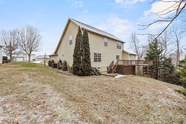 back of property featuring a deck and a yard