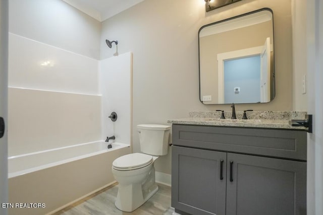 full bathroom with hardwood / wood-style floors, vanity,  shower combination, and toilet