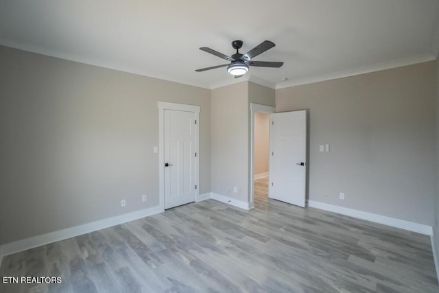 unfurnished bedroom with ceiling fan, crown molding, and light hardwood / wood-style floors