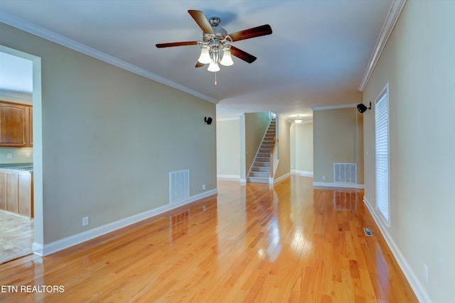 unfurnished living room with light hardwood / wood-style floors, ceiling fan, and ornamental molding