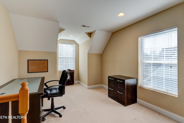 office space with light colored carpet and lofted ceiling