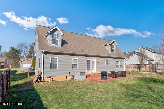 rear view of house featuring a yard, a patio, and central air condition unit