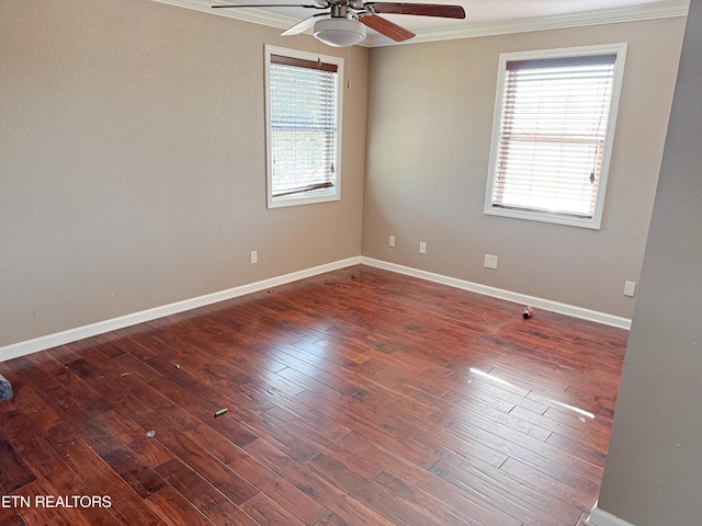 unfurnished room featuring dark wood-type flooring, ornamental molding, a healthy amount of sunlight, and ceiling fan