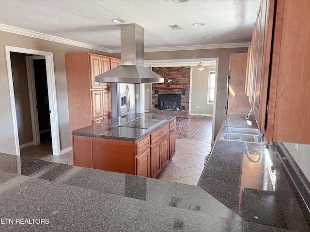 kitchen featuring ornamental molding, a kitchen island, sink, and island range hood