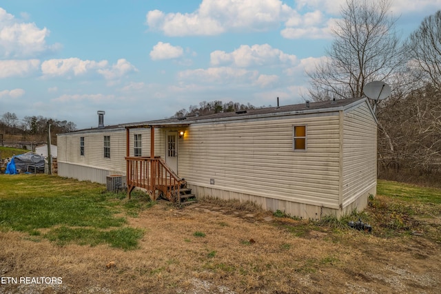 rear view of house with a yard