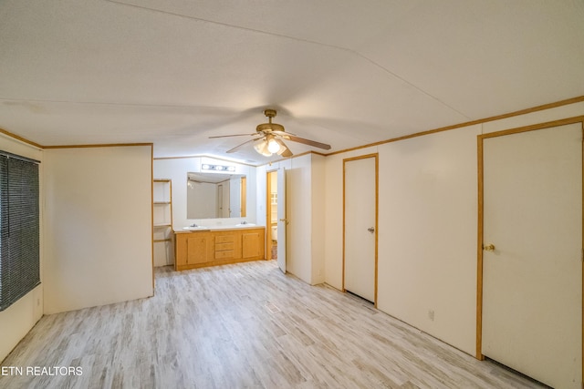 unfurnished bedroom featuring connected bathroom, light hardwood / wood-style flooring, ceiling fan, and ornamental molding