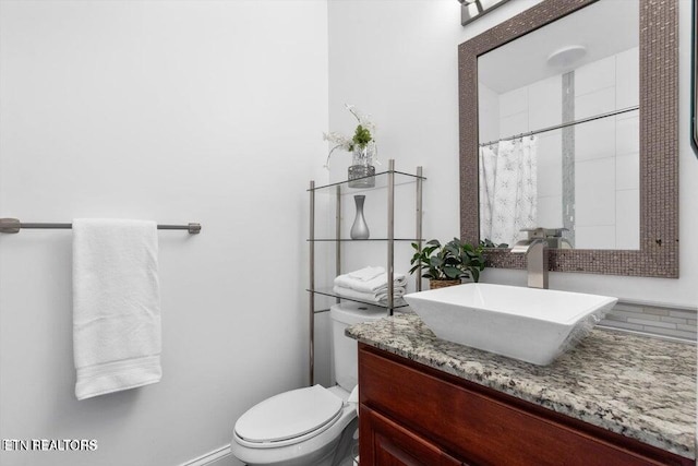 bathroom with vanity and toilet