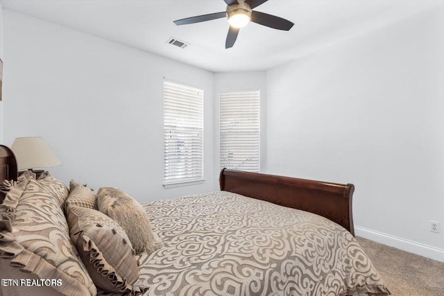 bedroom with ceiling fan and light colored carpet