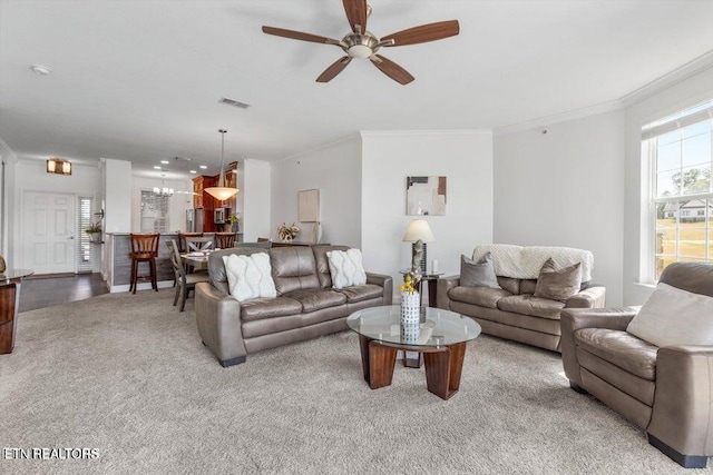 living room with light carpet, ceiling fan, and ornamental molding