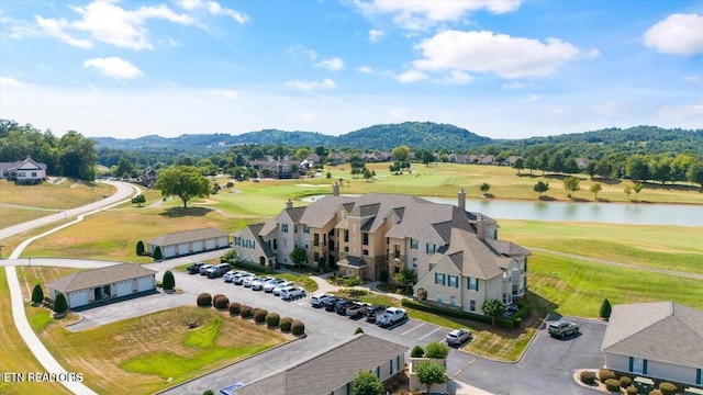 birds eye view of property with a water and mountain view