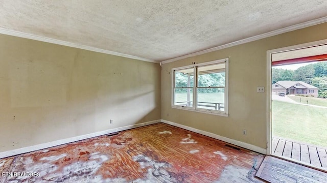 empty room featuring ornamental molding and a textured ceiling