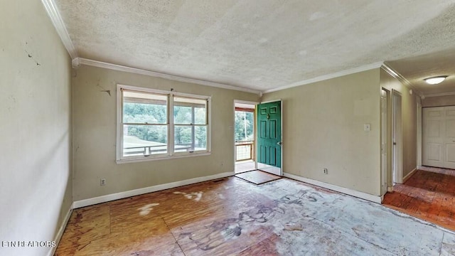 unfurnished room featuring crown molding and a textured ceiling