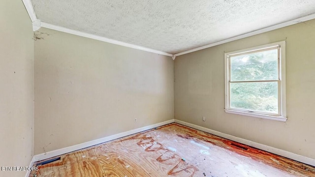 spare room with ornamental molding and a textured ceiling