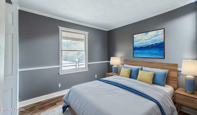 bedroom featuring hardwood / wood-style flooring and ornamental molding