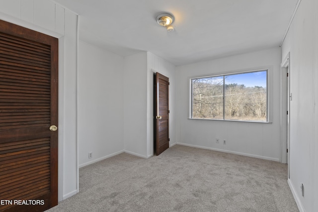 unfurnished bedroom featuring light carpet