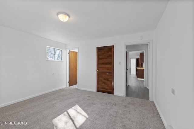 unfurnished bedroom featuring carpet and a closet