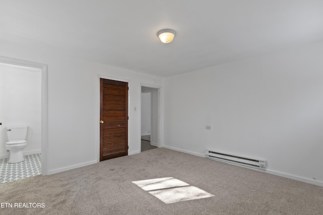 unfurnished bedroom with a baseboard radiator, ensuite bath, a closet, and carpet