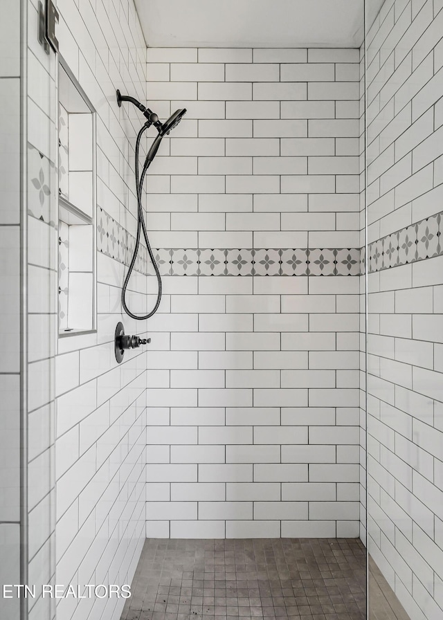 bathroom with tiled shower