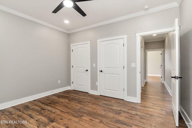 unfurnished bedroom featuring ceiling fan, crown molding, and dark hardwood / wood-style flooring