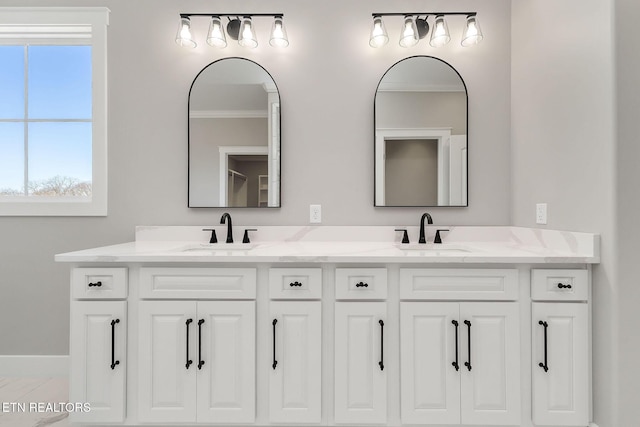 bathroom featuring crown molding and vanity