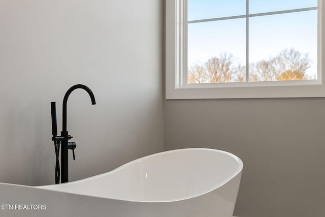 bathroom featuring sink and a tub