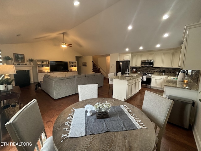 dining room featuring recessed lighting, dark wood-style flooring, a ceiling fan, vaulted ceiling, and stairway