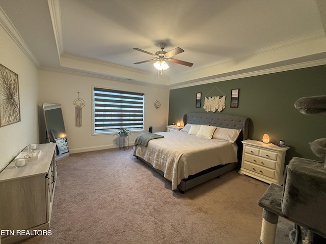 carpeted bedroom with a raised ceiling, ceiling fan, and crown molding