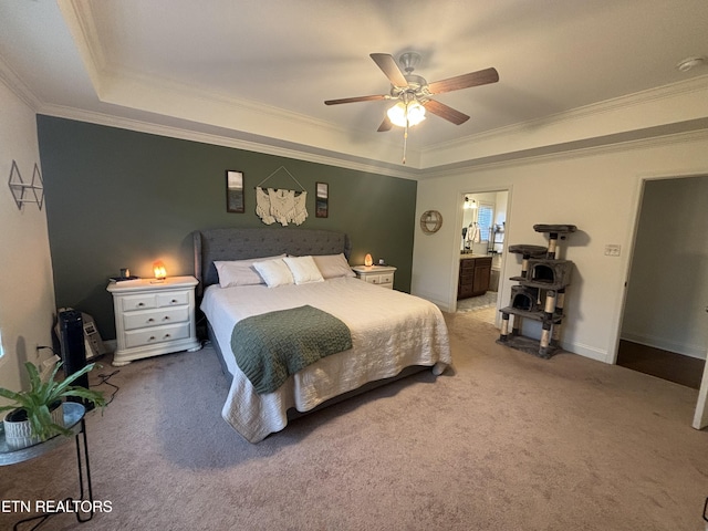 bedroom featuring carpet, a tray ceiling, baseboards, and ornamental molding