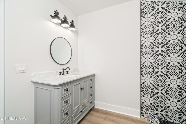 bathroom with vanity and hardwood / wood-style flooring