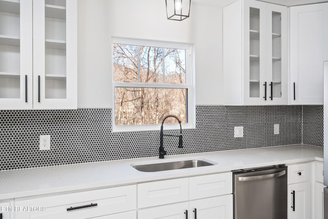 kitchen with white cabinets, backsplash, and dishwasher