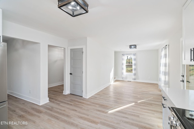 unfurnished living room with light wood-type flooring